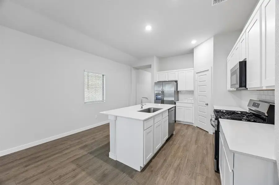 Kitchen in the Cedar home plan by Trophy Signature Homes – REPRESENTATIVE PHOTO