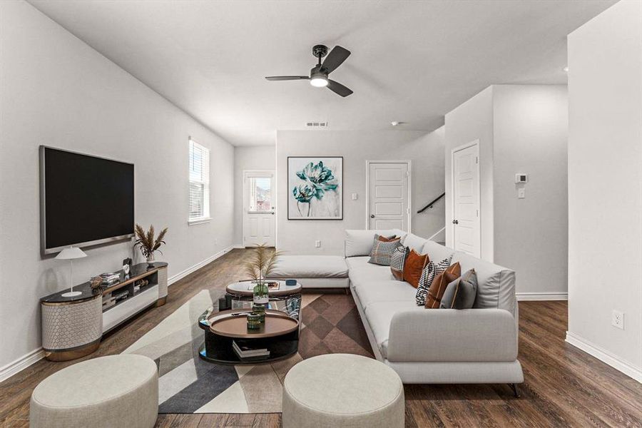 Living room featuring dark wood finished floors and a ceiling fan Living room featuring dark wood finished floors and a ceiling fan