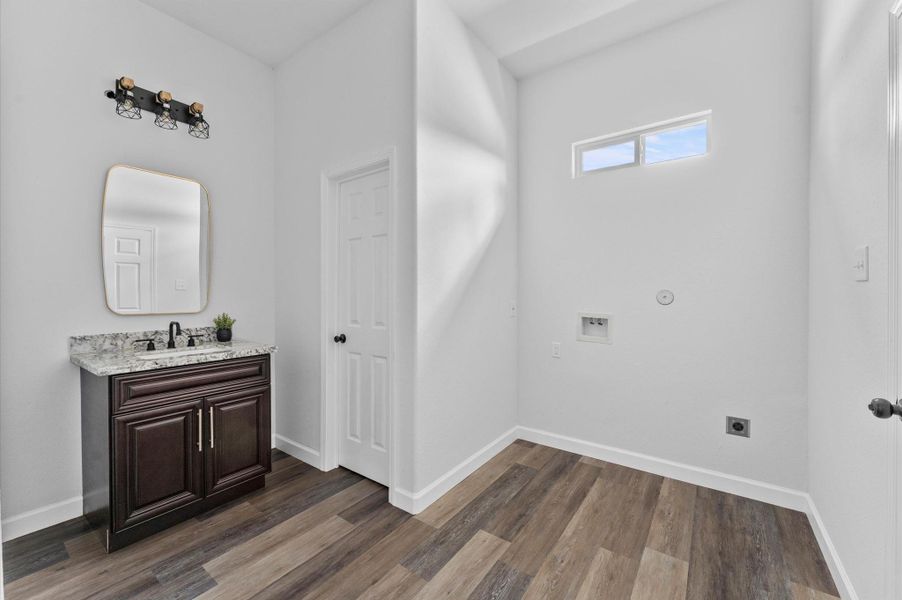 Dedicated laundry with room for full-size units and additional storage and half bathroom. Dedicated laundry with room for full-size units and additional storage and half bathroom.