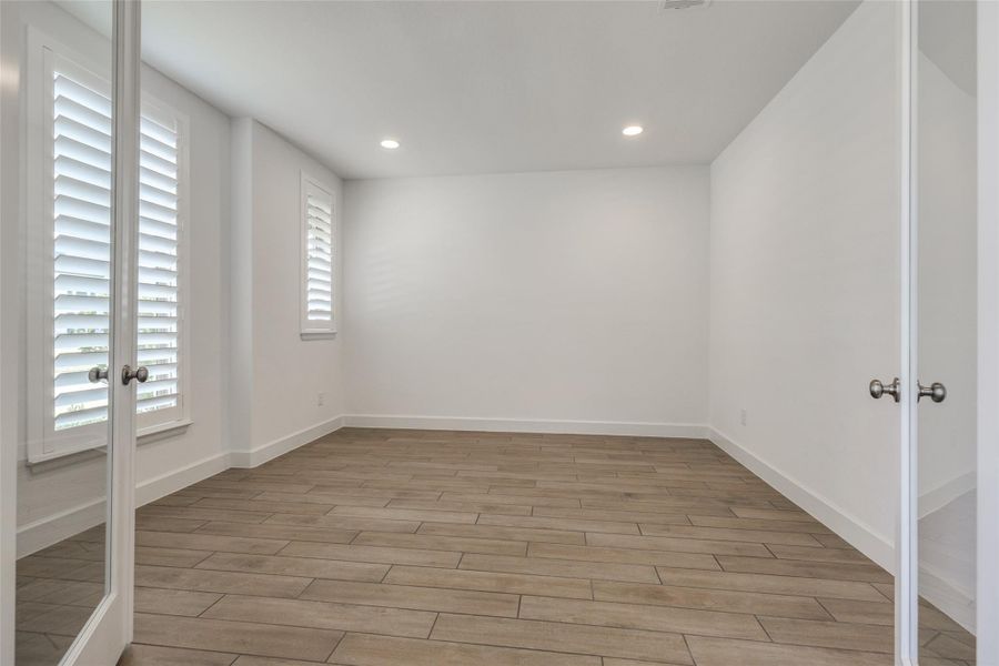 Study to the front of the home with glass doors for privacy, wooden plantation shutters