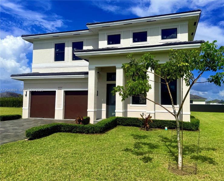 Front exterior of a new home in , Homestead, FL, highlighting curb appeal (Image 19). Front exterior of a new home in , Homestead, FL, highlighting curb appeal (Image 19).