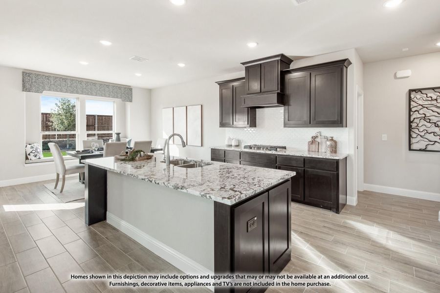 Kitchen with dark cabinets, granite island with sink, and tile floors open to dining area Kitchen with dark cabinets, granite island with sink, and tile floors open to dining area