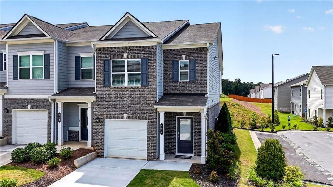 Front exterior of a new home in Fuller Station, Loganville, GA, highlighting curb appeal (Image 27).