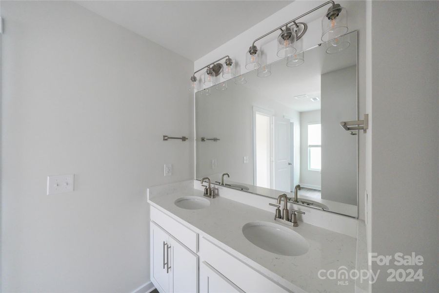 Secondary Bathroom w/ sink area separated for multi-person use