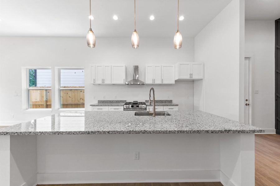 Spacious kitchen island boasts a built-in sink and dishwasher, offering ample workspace and convenience for meal prep and entertaining. The perfect centerpiece for gatherings and everyday living.