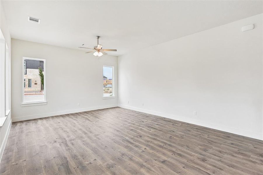 Unfurnished room with wood-type flooring and ceiling fan