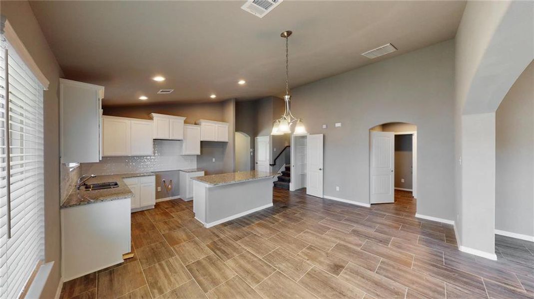 The living area offers a spacious and flexible layout, ideal for both relaxation and entertaining. The large windows provide plenty of natural light, enhancing the room's welcoming ambiance. The open design allows for easy interaction with the kitchen and dining areas. This is a picture of an Elise Floor Plan with another Saratoga Homes.