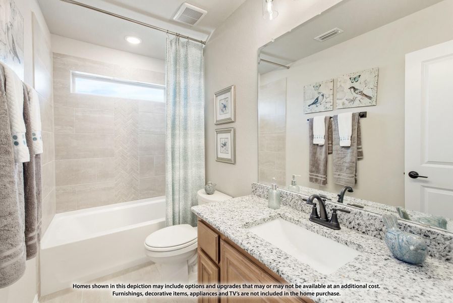 Bathroom with granite countertop vanity, tiled tub-shower combo, and large mirror Bathroom with granite countertop vanity, tiled tub-shower combo, and large mirror