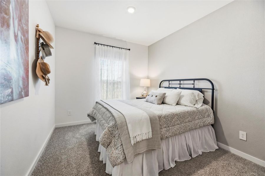 Enlarged first-floor secondary bedroom with a designer accent wall and a dedicated wardrobe closet.