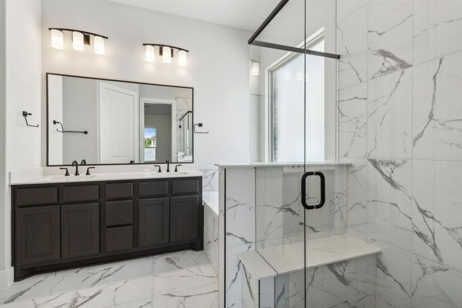 Bathroom with a shower with shower door and vanity