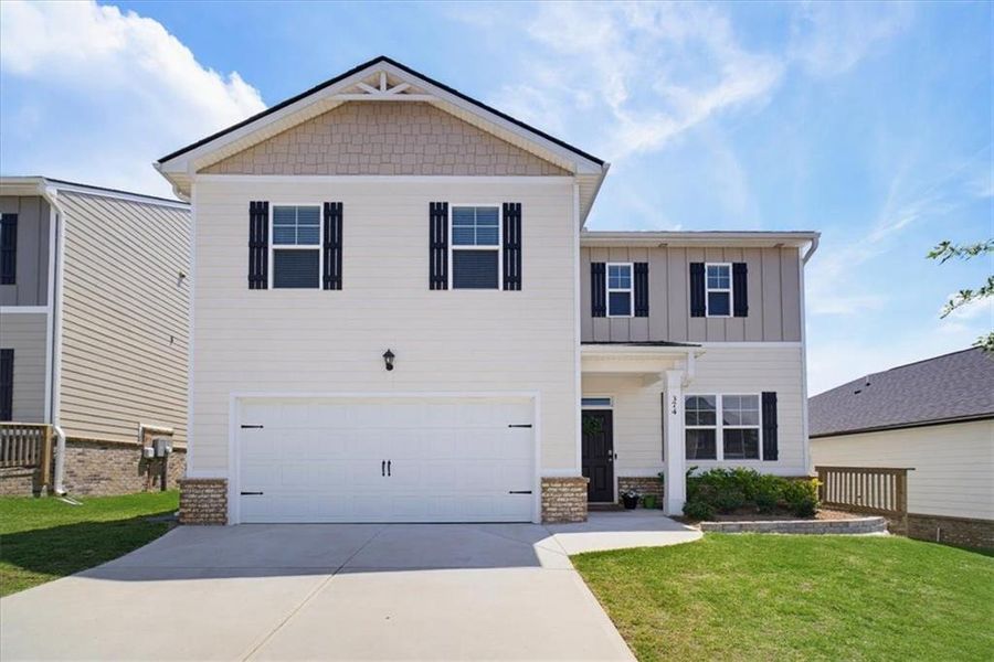 Front exterior of a new home in Twin Lakes, Hoschton, GA, highlighting curb appeal (Image 2). Front exterior of a new home in Twin Lakes, Hoschton, GA, highlighting curb appeal (Image 2).
