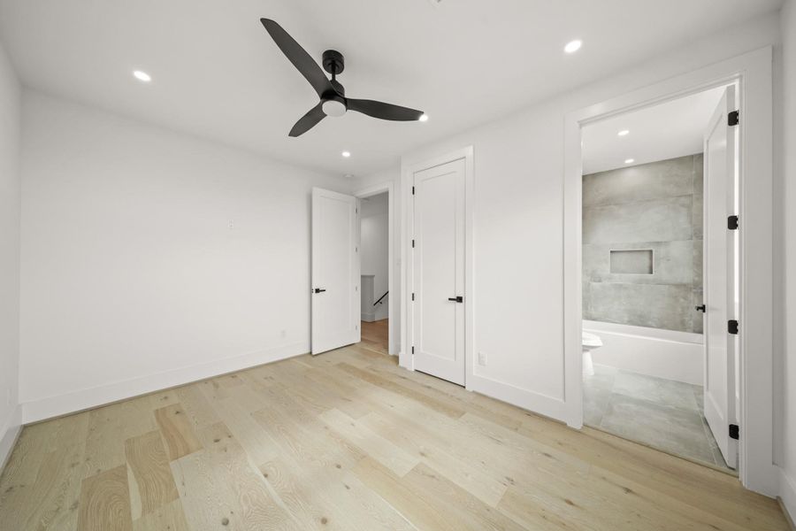A view of the second bedroom with the third floor corridor in the background as well as access to the ensuite bath.