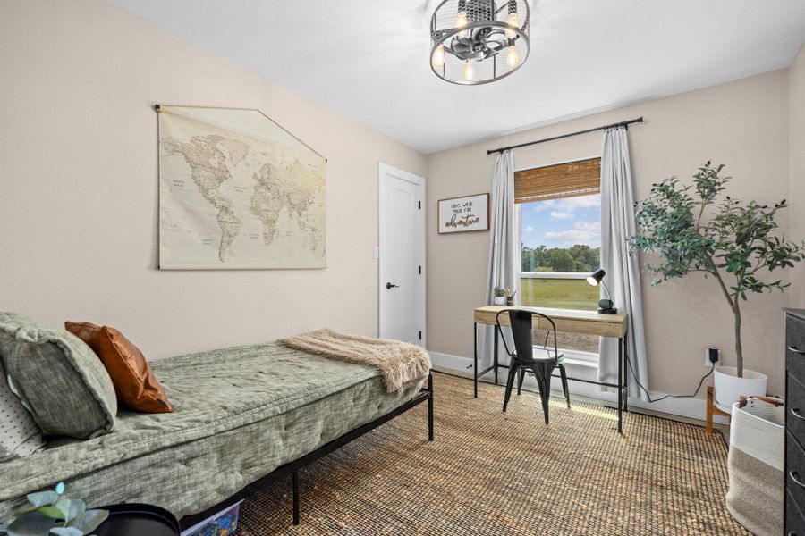 Carpeted bedroom featuring baseboards