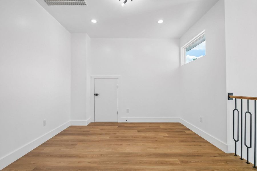 Smooth wood floors and crisp white walls define this versatile upper-level landing space. Smooth wood floors and crisp white walls define this versatile upper-level landing space.