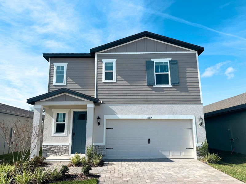 Front exterior of a new home in Two Rivers - Premier Series, Zephyrhills, FL, highlighting curb appeal (Image 1). Front exterior of a new home in Two Rivers - Premier Series, Zephyrhills, FL, highlighting curb appeal (Image 1).
