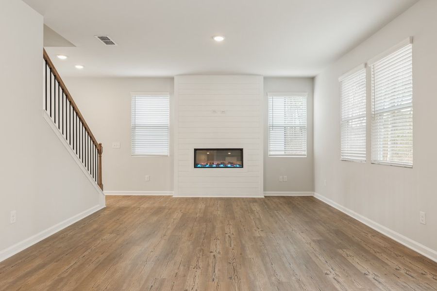 A room with a fireplace and a wood floor.