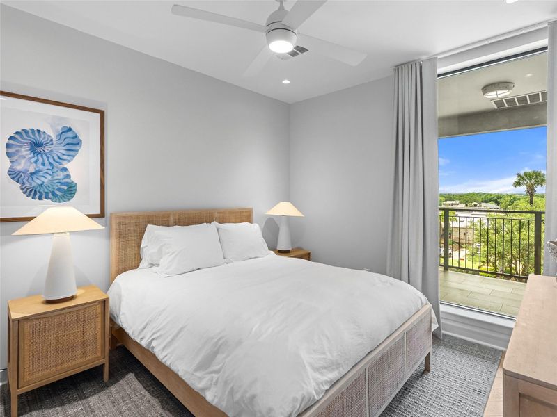 Bedroom with a sliding glass door opening to a private balcony Bedroom with a sliding glass door opening to a private balcony