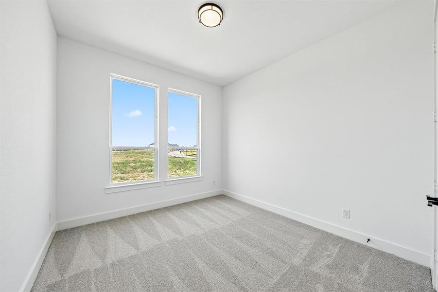Unfurnished room featuring carpet and baseboards