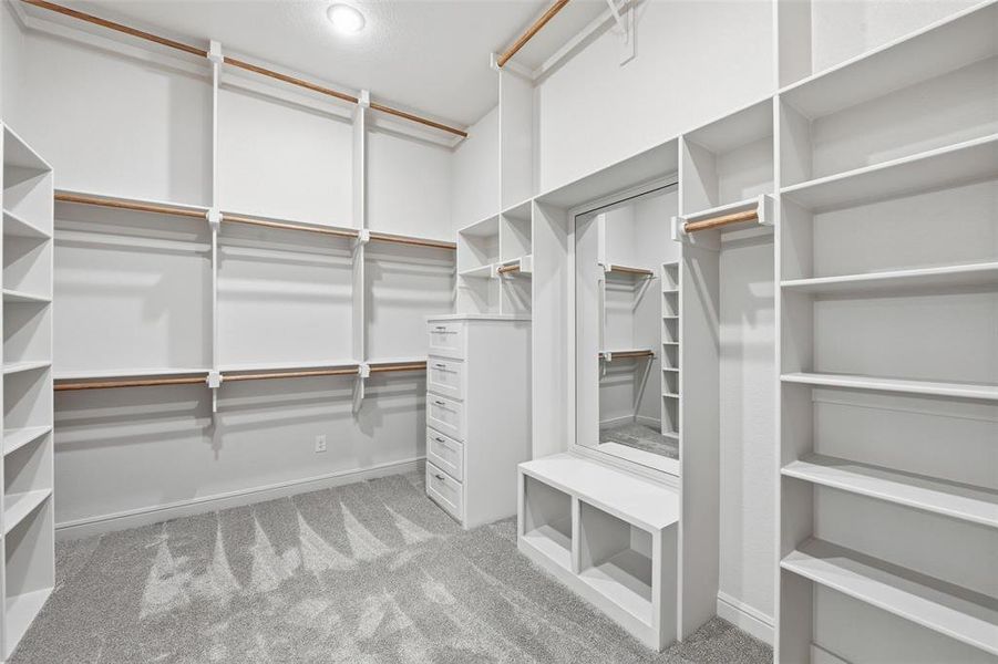 Spacious closet with light colored carpet Spacious closet with light colored carpet