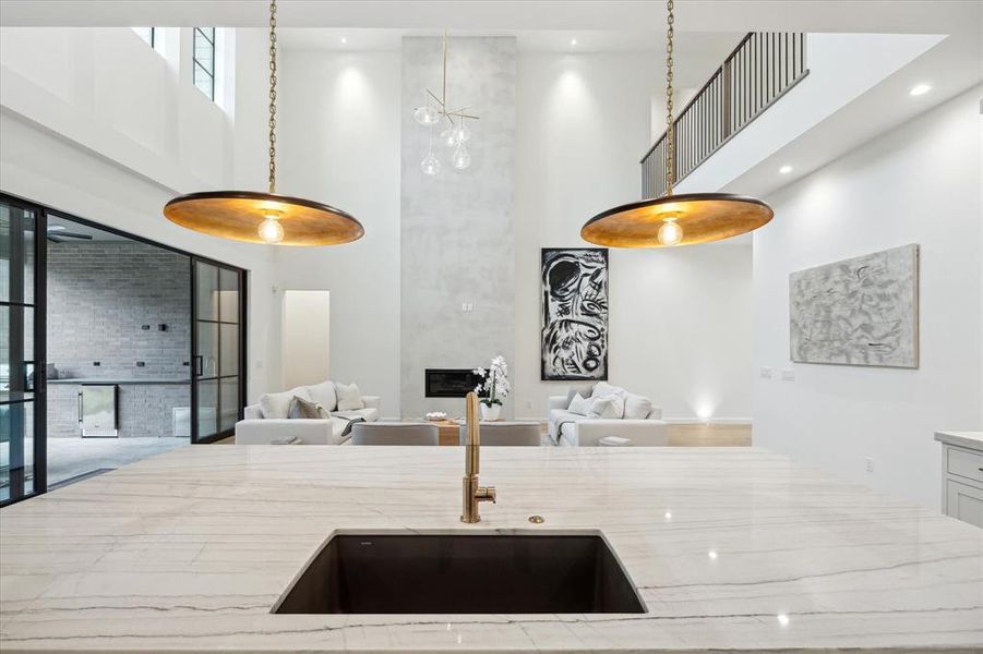 Modern lighting fixtures and clean, neutral finishes provide a bright, sophisticated feel throughout the home. The combination of natural and recessed lighting makes the space feel open and inviting.