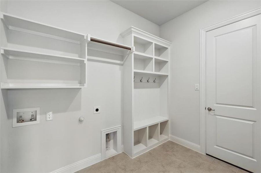 Washroom featuring laundry area, baseboards, hookup for a washing machine, electric dryer hookup, and hookup for a gas dryer Washroom featuring laundry area, baseboards, hookup for a washing machine, electric dryer hookup, and hookup for a gas dryer