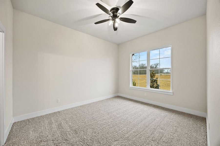 Unfurnished room featuring carpet flooring and ceiling fan Unfurnished room featuring carpet flooring and ceiling fan