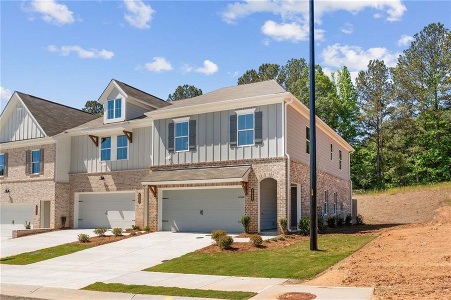 Front exterior of a new home in Wildwood Place, Powder Springs, GA, highlighting curb appeal (Image 22).