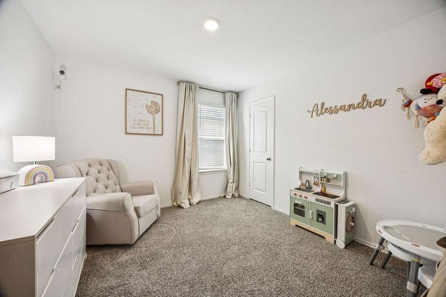 Charming bedroom with plush carpeting, abundant natural light, and space for play and relaxation, perfect for creating a cozy retreat. Charming bedroom with plush carpeting, abundant natural light, and space for play and relaxation, perfect for creating a cozy retreat.