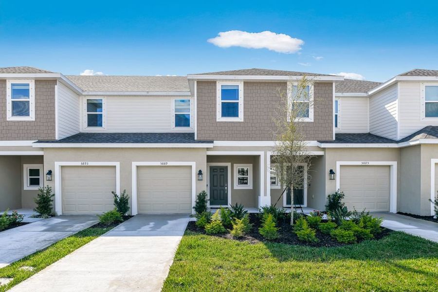 Front exterior of a new home in Vinterra Townhomes, Nokomis, FL, highlighting curb appeal (Image 1).