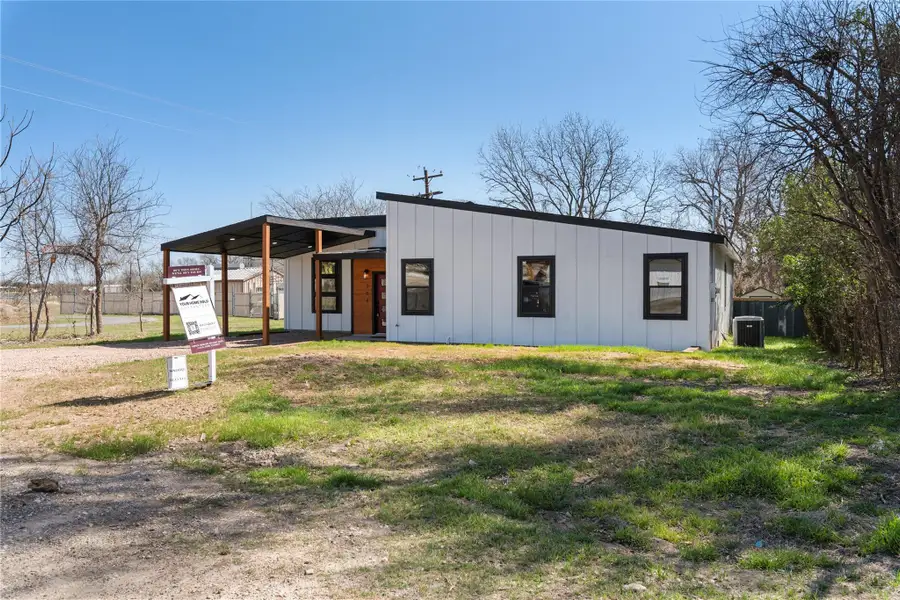 View of front of house with central air condition unit, fence, board and batten siding, and driveway