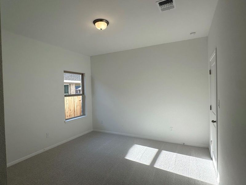 Carpeted spare room featuring baseboards Carpeted spare room featuring baseboards