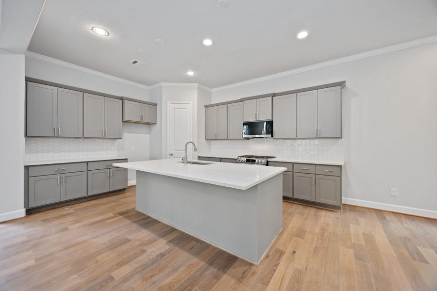 This kitchen checks every box: Benedettini cabinetry, quartz counters, included pulls, and a big island that’s perfect for everything from pancake breakfasts to wine night.