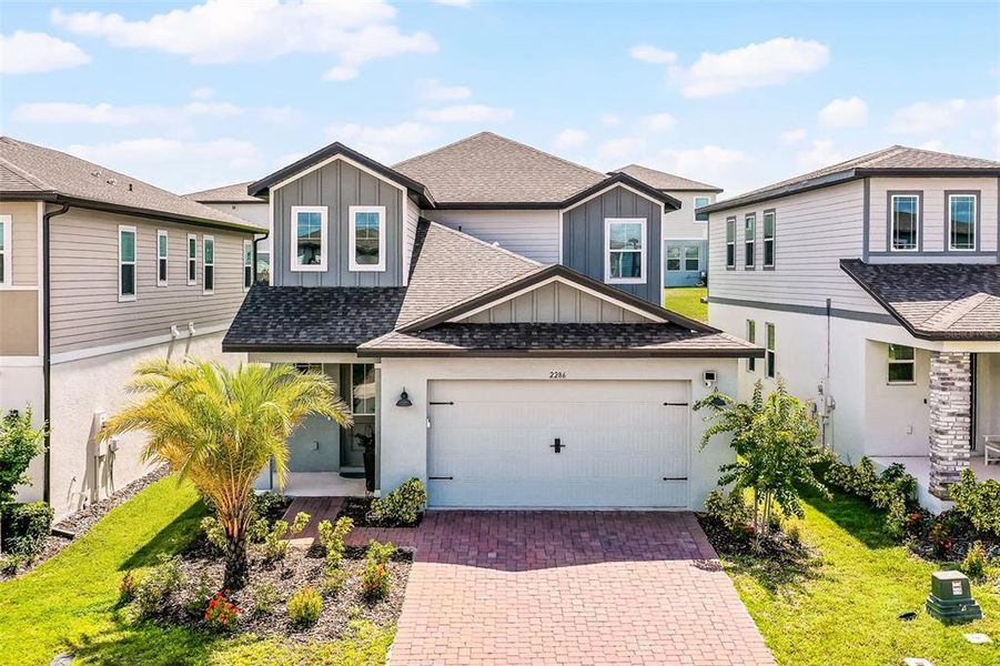 Front exterior of a new home in , Minneola, FL, highlighting curb appeal (Image 20).