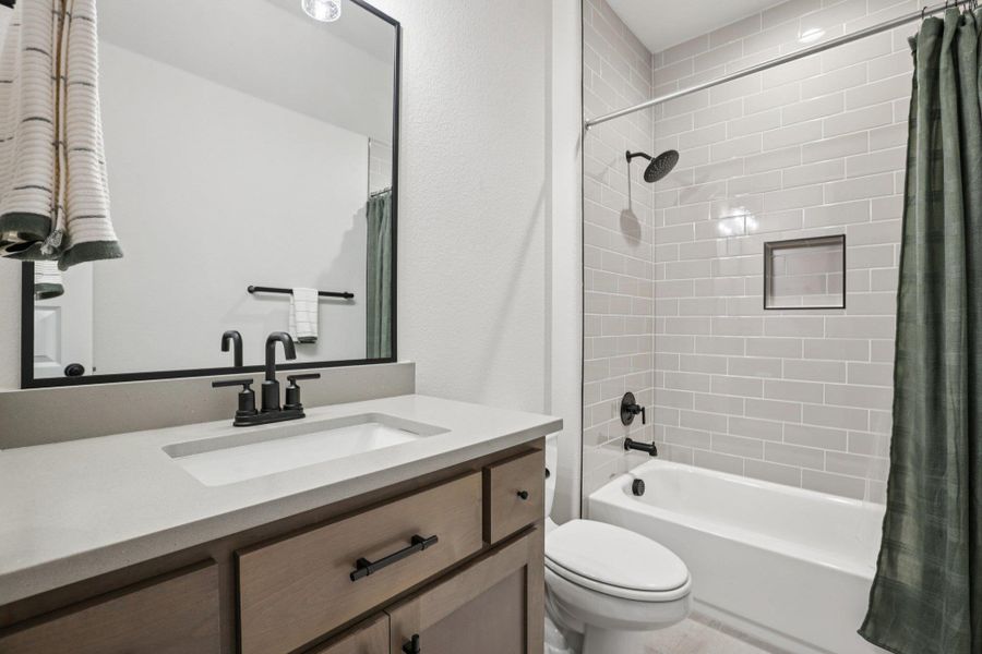 The second level hosts two additional secondary bedrooms, each with private en-suite baths.