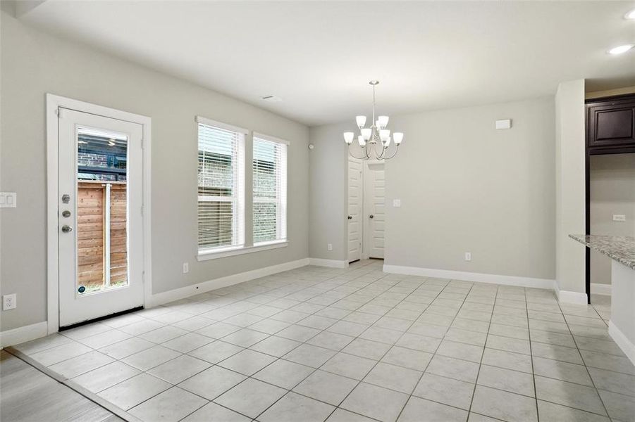 and open concept dining with breakfast bar island into kitchen