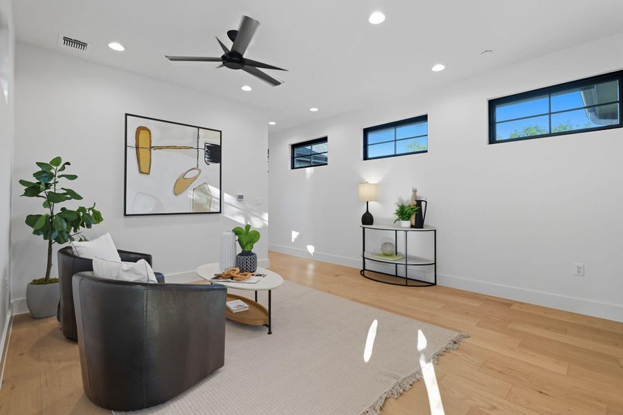 Sitting room with light wood-style flooring, recessed lighting, and a ceiling fan