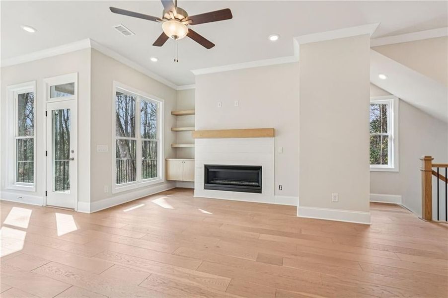 Check out the amount of natural light that comes into this END Unit - beautiful and upgraded hard surface flooring in Stateside Oak color- AV outlet for TV placement over fireplace