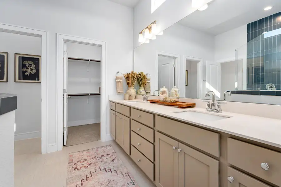 Bathroom with double vanity and a walk in closet Bathroom with double vanity and a walk in closet