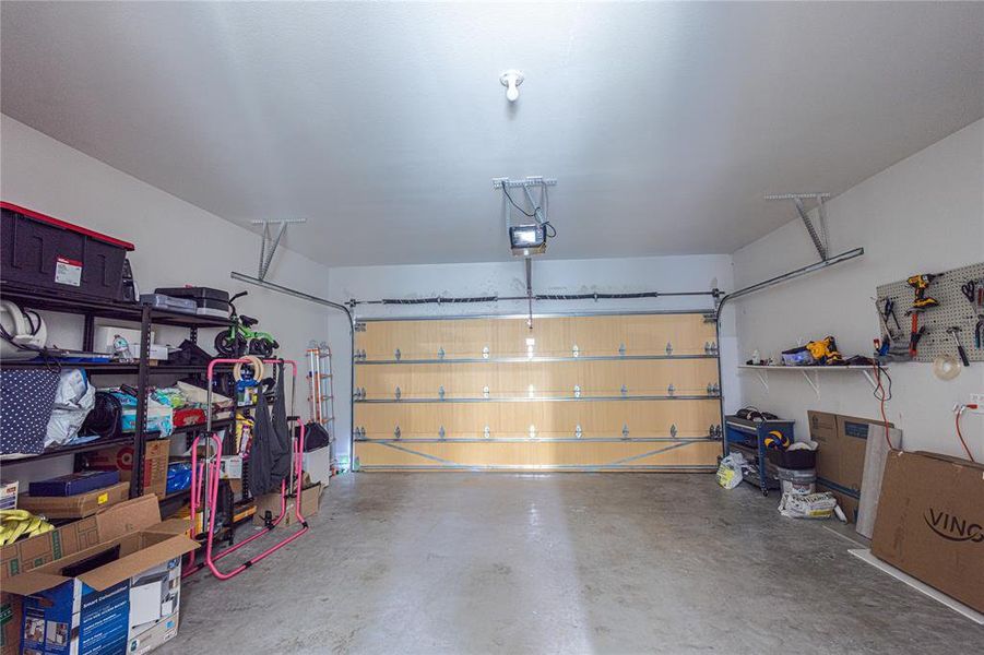 Garage featuring a garage door opener