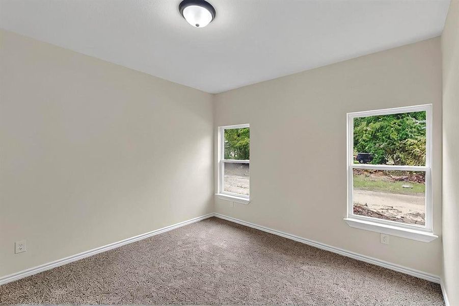Unfurnished room with carpet floors and baseboards Unfurnished room with carpet floors and baseboards