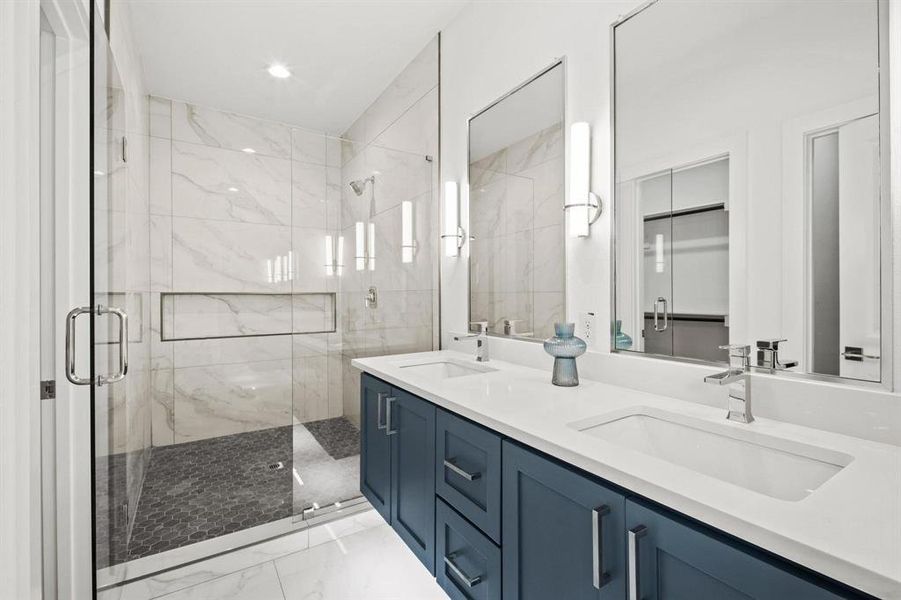 Bathroom with double vanity, a walk in closet, a marble finish shower, light marble finish floors, and recessed lighting