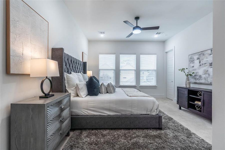 The primary bedroom is spacious with high ceilings.