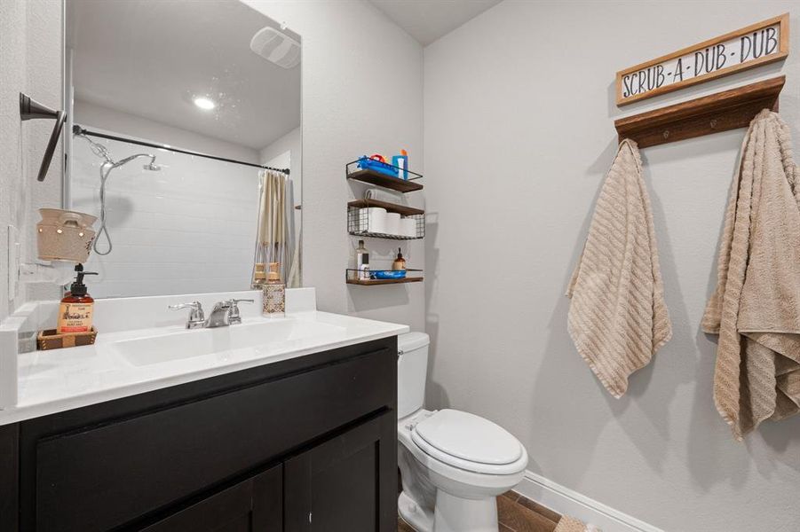 Full bath with curtained shower and vanity Full bath with curtained shower and vanity