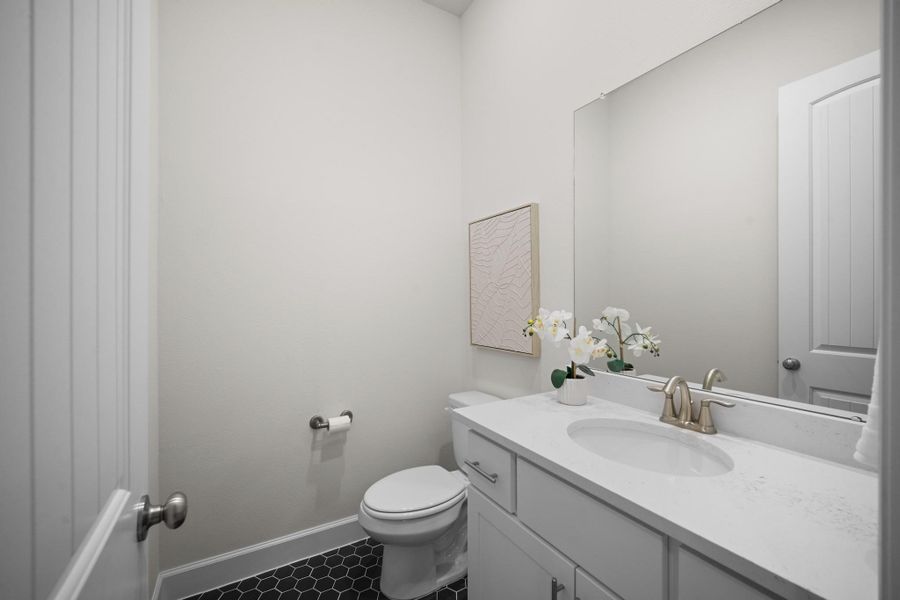 First-floor powder room with quartz counters, undermount sink, and black hexagon tile — a small room that got the details right. First-floor powder room with quartz counters, undermount sink, and black hexagon tile — a small room that got the details right.
