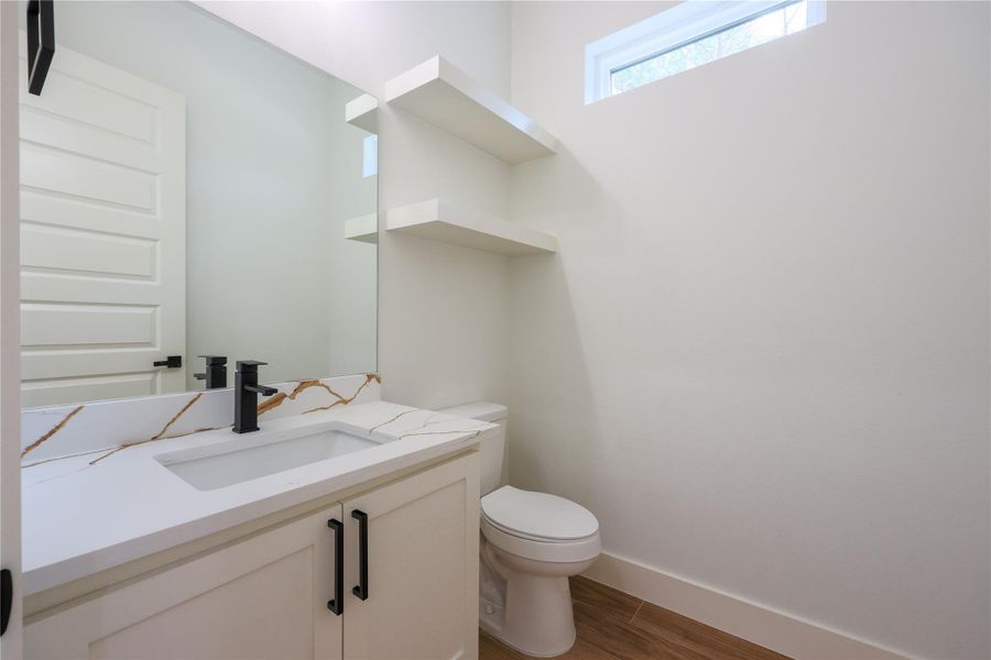Upgraded half bath with actual cabinets, shelves, quartz, and a window for natural lighting. Upgraded half bath with actual cabinets, shelves, quartz, and a window for natural lighting.