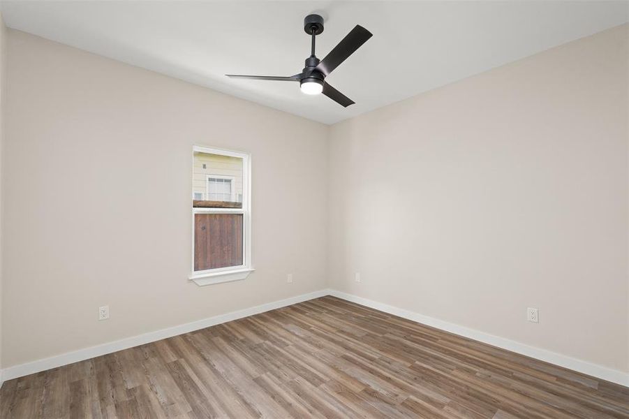 Unfurnished room with wood finished floors and ceiling fan