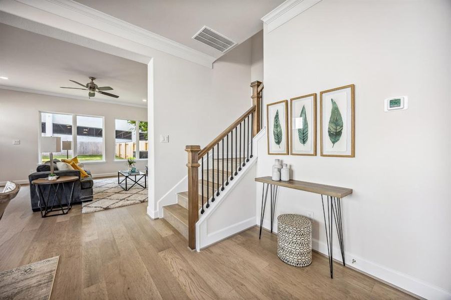 Make space for a cheerful vignette, dining sideboard or bookcase adjacent to the stairs.