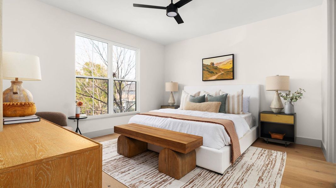 Bedroom with ceiling fan and light wood finished floors