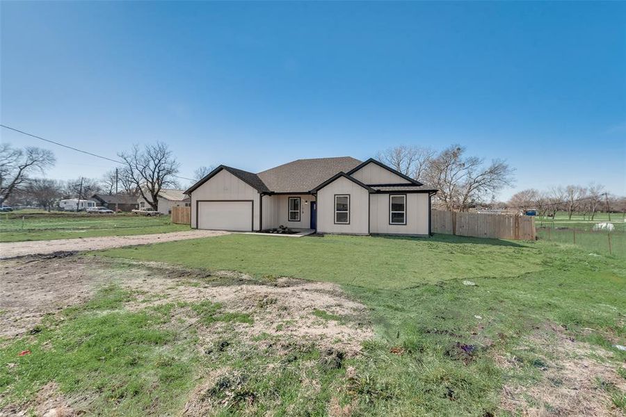 Ranch-style house with a garage and a front yard