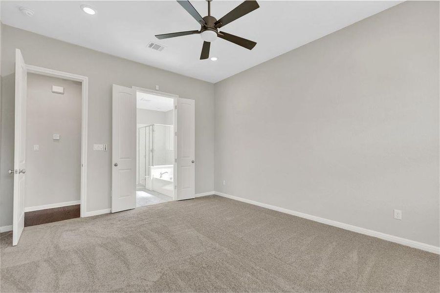Unfurnished bedroom with carpet, ensuite bath, ceiling fan, and recessed lighting Unfurnished bedroom with carpet, ensuite bath, ceiling fan, and recessed lighting